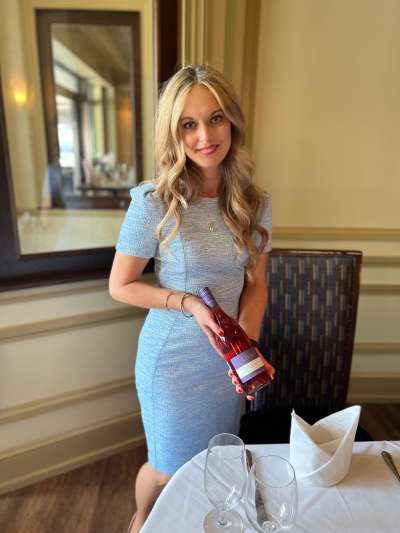 Woman, Blond Hair, Blue Dress, Holding a bottle of wine