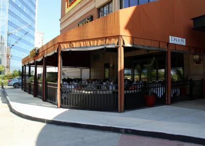 A view of the patio from the outside, covered by an orange awning
