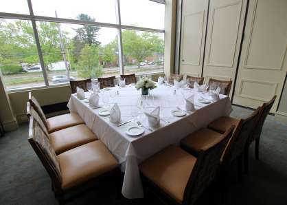 square table, semi private dining room with floor to ceiling windows