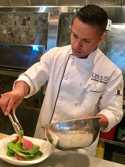 Andres Tavares prepares a dish in the kitchen