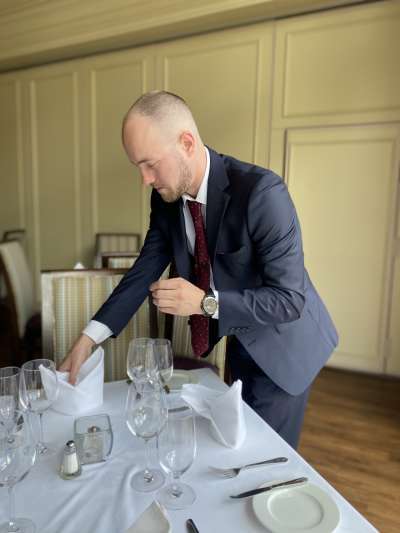 Man, blue suit, red tie, shaved head