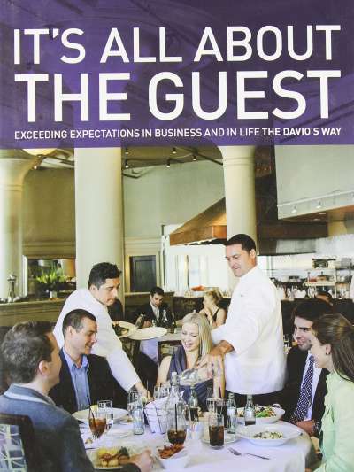 Cover of Steve DiFillippo's book, It's All About the Guest, showing a smiling group of guest being served in the Davio's Boston dining room