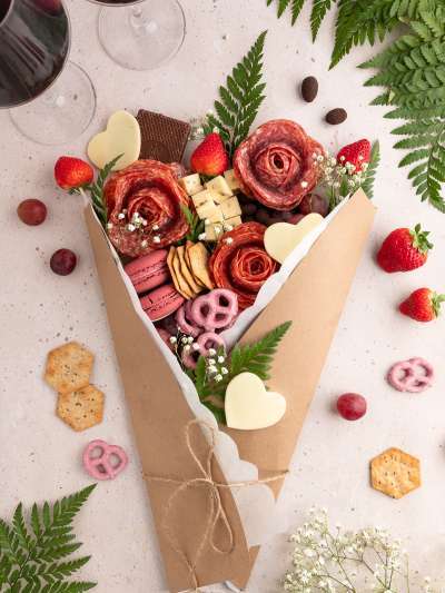 Charcuterie Bouquet with meats, cheeses, fruits, pretzels, wrapped in paper