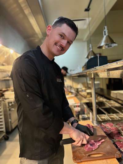 Man, Dark Chef Coat, Black Hair, Slicing Steak