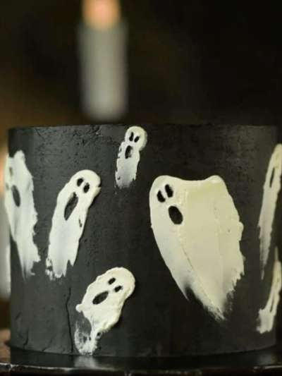 Halloween cake black icing with white Ghosts