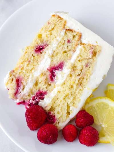 Slice of Lemon, Raspberry Cake, Raspberries and Lemon on plate