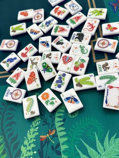 Mahjong tiles on a green tablecloth