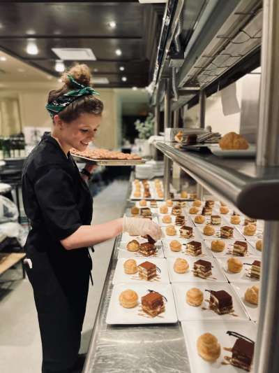 Woman, Black Chef Coat, Plating Desserts in the Kitchen
