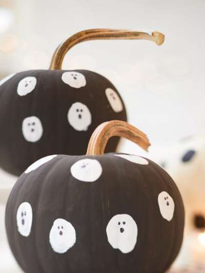 2 Pumpkins Painted with White Ghosts on them