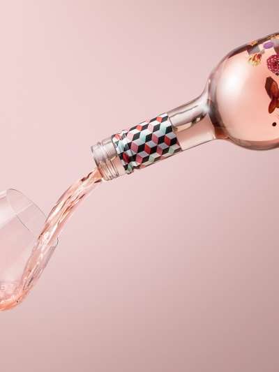 Summer in a Bottle Rose being poured into a glass at an angle