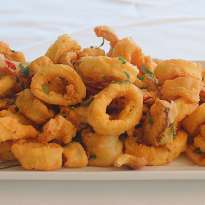 Calamari with Cherry Peppers and Aioli on a plate