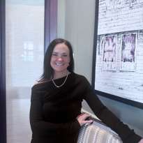 Woman, Long Dark Hair, Dark Dress Leaning on a Chair