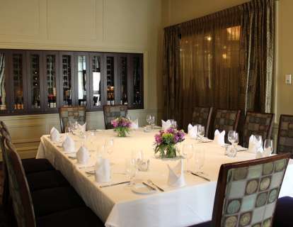 The Wine Room features a wall of wine storage, a tall window, and can be set conference style with a table for 12