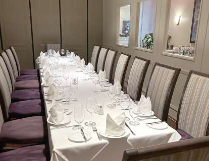 Long table in a room with windows