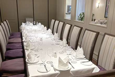 Long table in a room with windows
