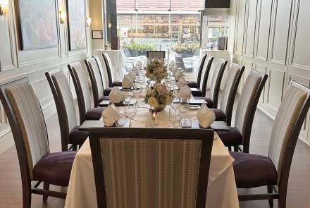 Pioneer Room long table with Hi Tops in the back of the room