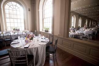 High arched windows light the main dining room, set for a wedding reception.